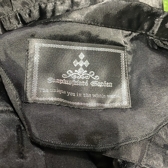 Ladies high neck sleeveless ruffle front top with corset detail in back. - Picture 3 of 5